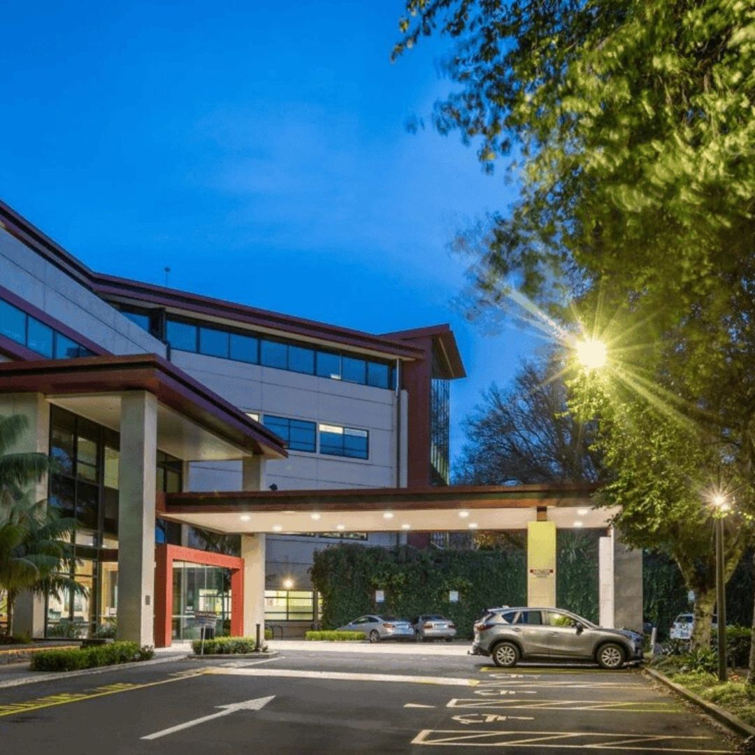 Front entrance of Allevia Hospital in New Zealand at dusk, redeveloped with new theatres and wards, protected by Passive Fire NZ’s compliant fire-stopping systems.