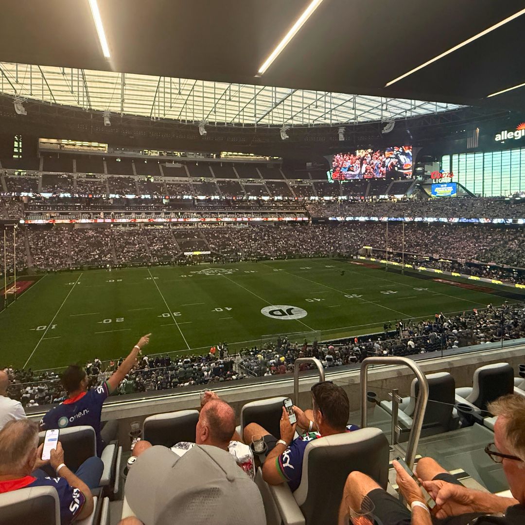 Passive Fire NZ team and construction leaders from across NZ at Allegiant Stadium in Las Vegas, supporting the NZ Warriors and celebrating high-performance teamwork.