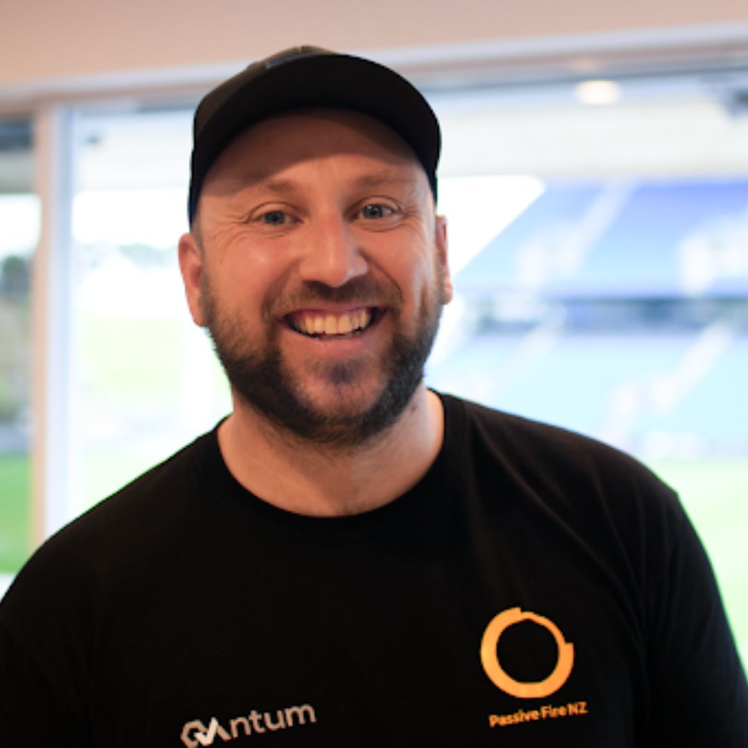 Passive Fire NZ General Manager smiling at stadium venue