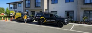 Passive Fire NZ site team vehicles at Summerset Cambridge Village during installation of passive fire protection systems.